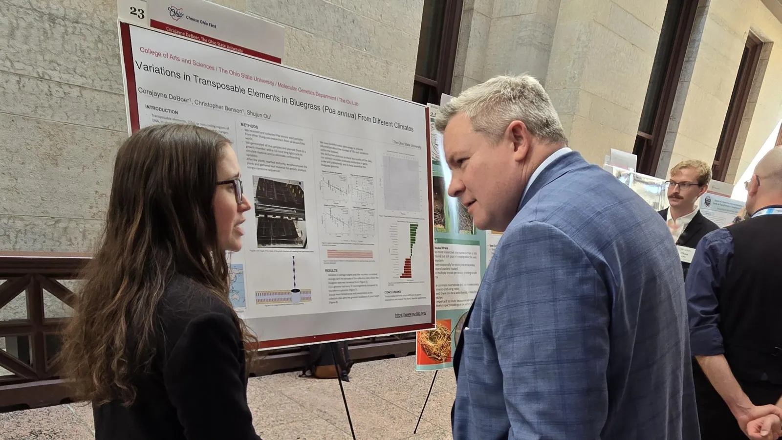 Corajayne presenting her poster to the Chancellor of the Ohio Department of Higher Education Mike Duffey